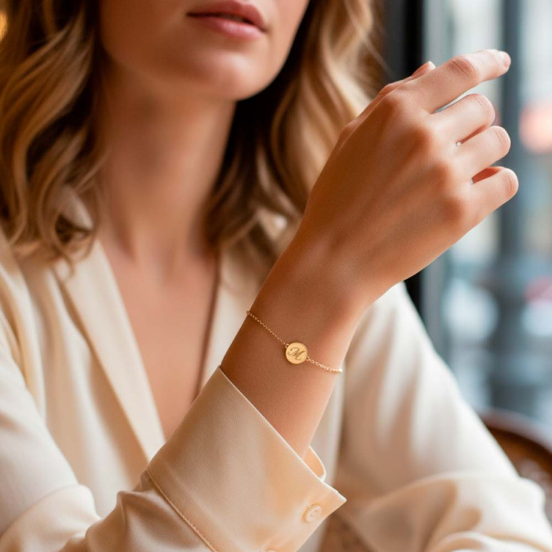 gold bracelet with engraved medal and initial