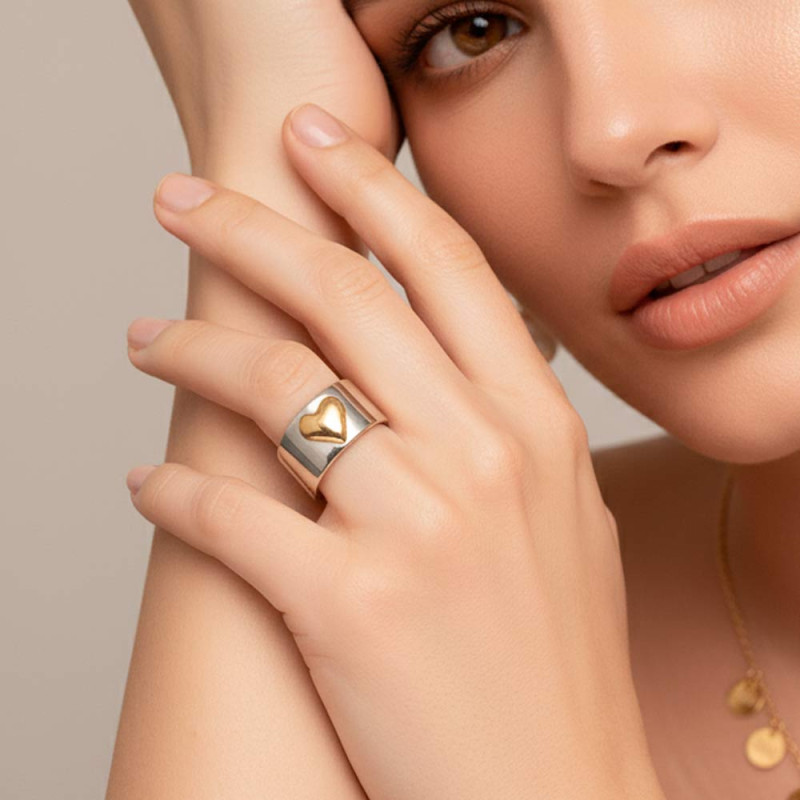 Woman wearing a personalized silver and gold heart ring