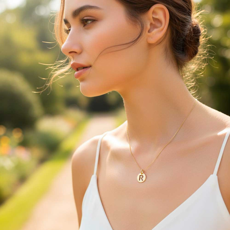 Cut-out initial gold pendant