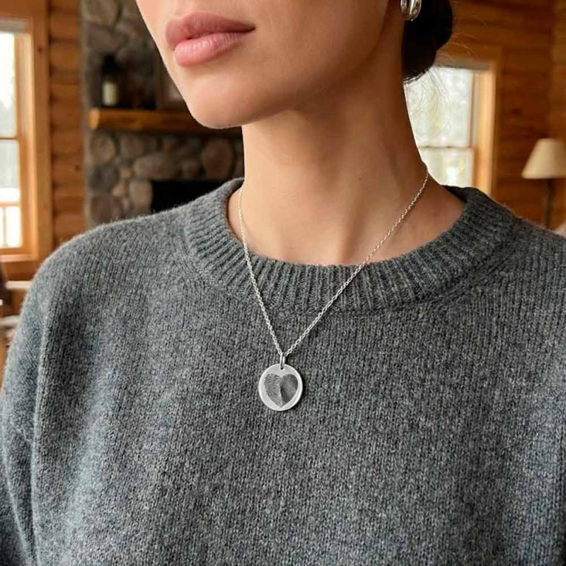 Women's footprint pendant with silver chain.