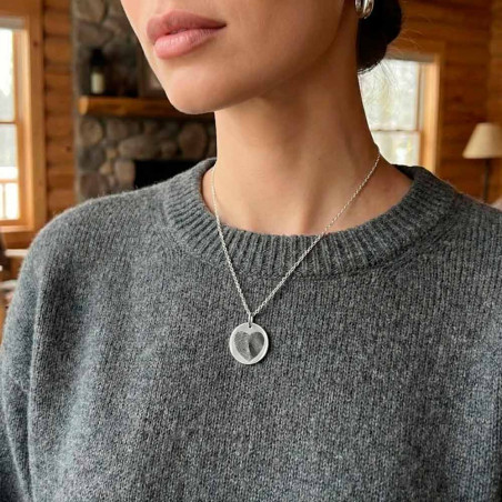 Women's footprint pendant with silver chain.