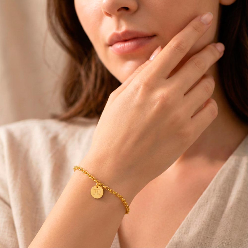 Women's gold bracelet with personalized name medal