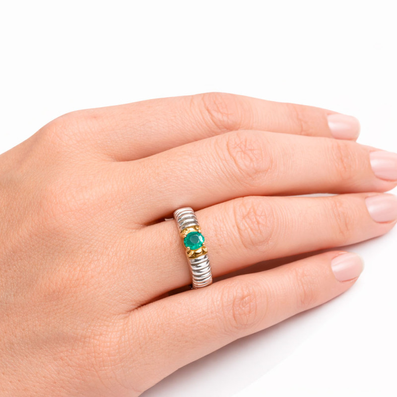 Galloped ring with an emerald set in silver and gold