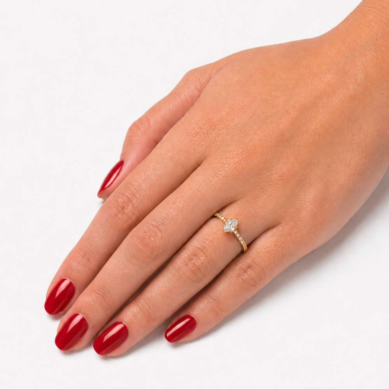 Gold engagement ring with a marquise-cut diamond.