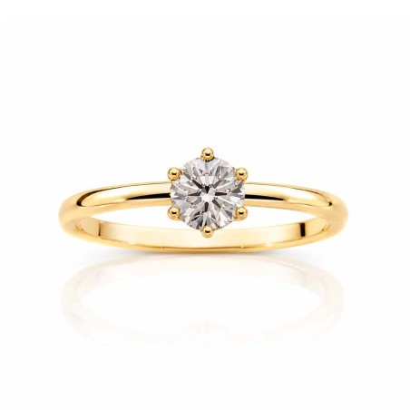 Gold solitaire ring with a cubic zirconia set in six prongs.