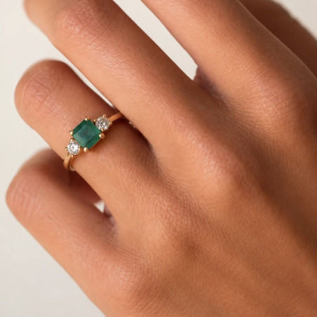 Gold ring with square emerald and diamonds worn on the hand