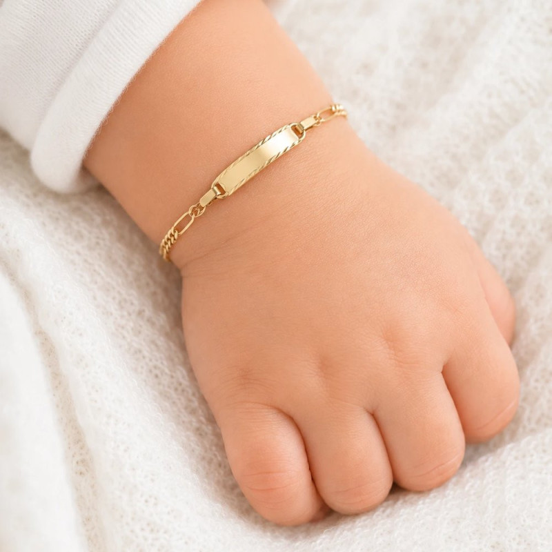 Gold ID bracelet with engraved-edge plate on a baby wrist