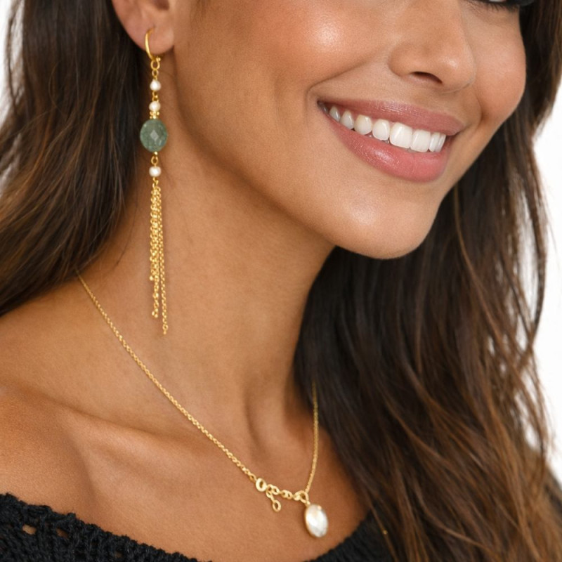Long tourmaline and pearl earrings worn on the ear