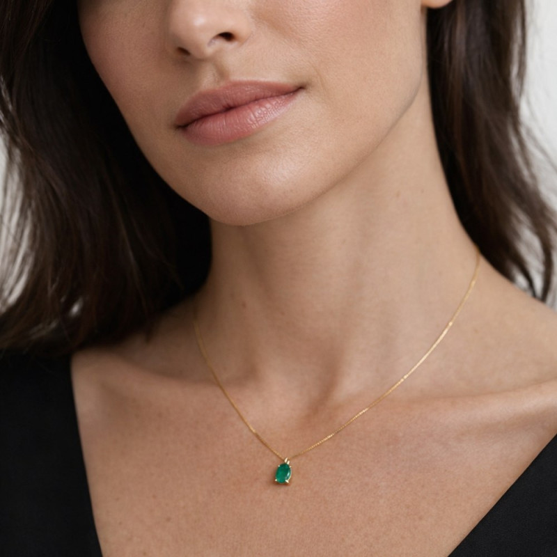 Gargantilla de oro con esmeralda oval puesta en el cuello