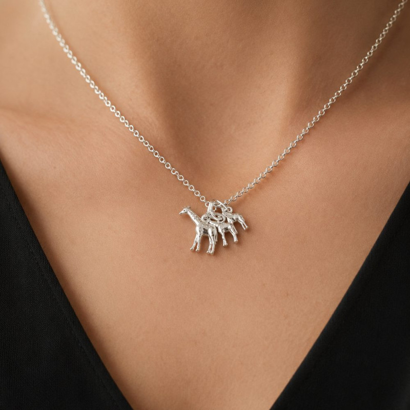 Silver giraffe necklace on the skin