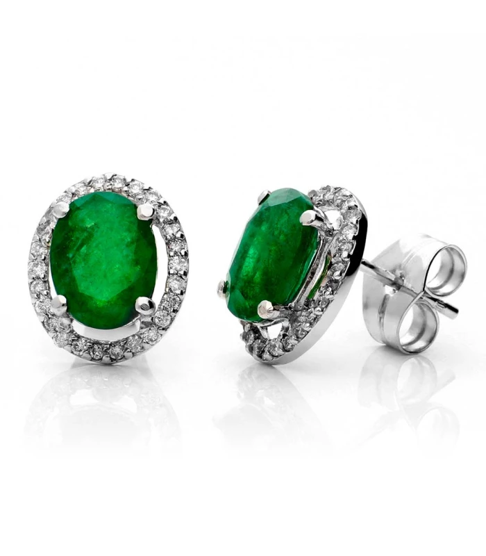 White gold earrings mounted with a central emerald and diamonds around