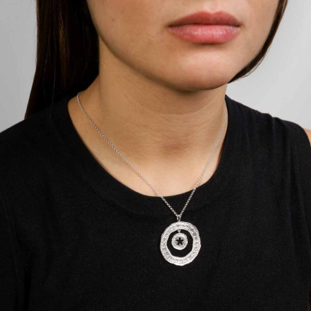 colgante de mujer en forma de circulo con textura rugosa y un jazmin