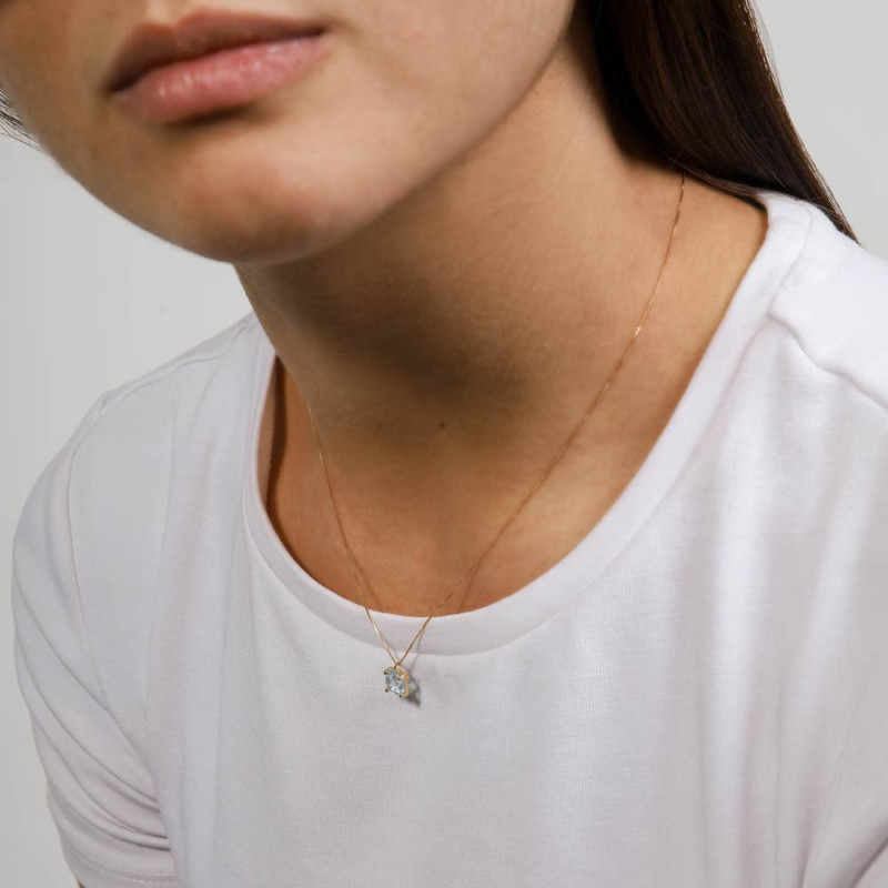 Women's gold necklace with a square topaz