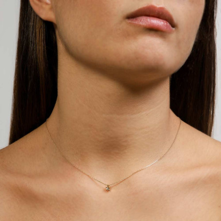 Women's gold necklace with a diamond.