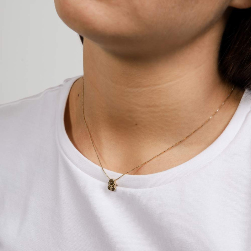 Gold necklace for mothers in the shape of a baby with a diamond in the center