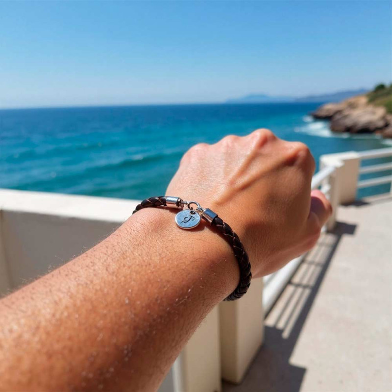 pulsera marron de cuero con una medalla de plata con inicial